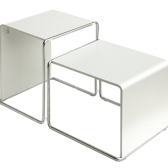 White minimalist nesting tables with sleek chrome frames, featuring a clean, modern design suitable for any decor.