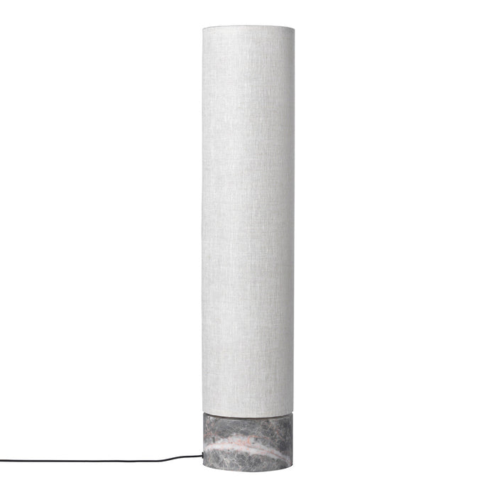 White cylindrical lamp with a textured fabric shade and a contrasting marble base. Elegant and modern design.