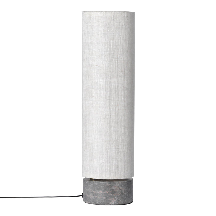 White cylindrical lamp with a textured fabric shade and a contrasting gray concrete base.