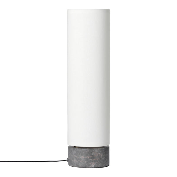 White cylindrical lamp with a sleek gray concrete base, featuring a minimalist and modern design.