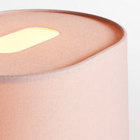Soft pink lamp with a sleek, curved silhouette and a warm, glowing yellow interior. Ideal for modern decor.