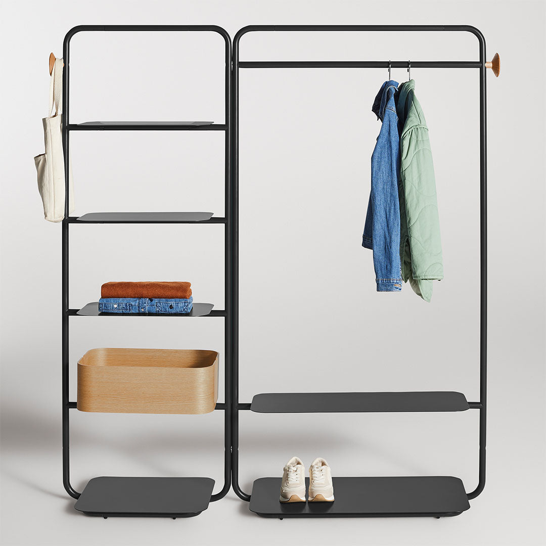 Modern black metal frame with natural wood accents, featuring solid shelves and hooks in soft pastel tones.