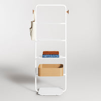 White metal shelving unit with layered shelves, featuring brown and blue towels, and a beige storage basket.