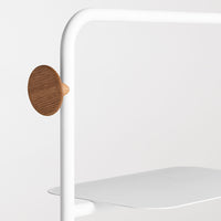 White metal frame with a smooth, flat shelf and a round, natural wood accent. Minimalist design with clean lines.