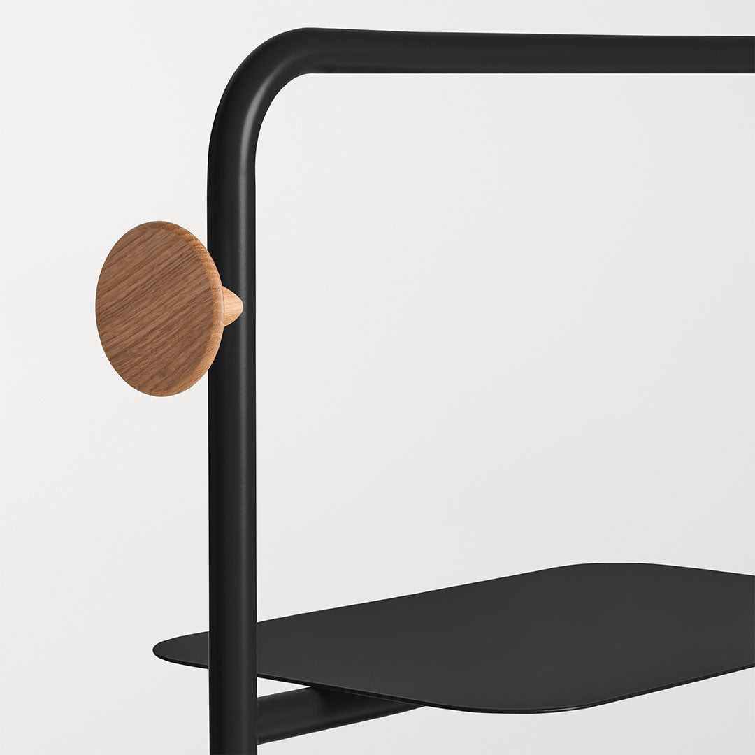 Black metal frame with a round wooden accent, featuring a sleek, modern design on a minimalist backdrop.