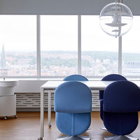 Two blue office chairs in gradient shades, set against a modern workspace backdrop with a sleek white table.