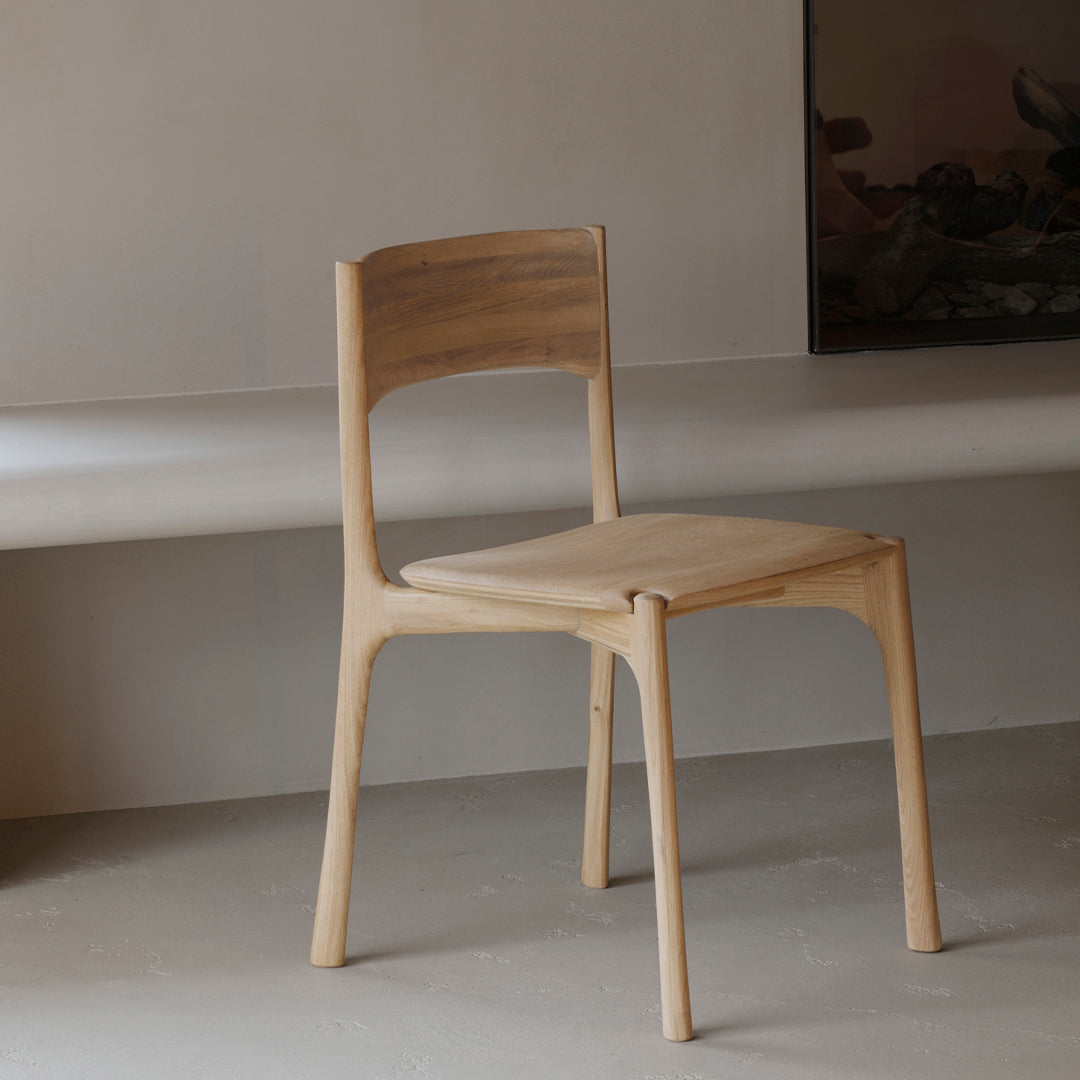 Natural wood chair in light beige with a minimalist design and smooth finish. Perfect for modern interiors.