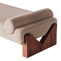 Beige textured upholstery with a rounded bolster, featuring a contrasting dark wood base in a modern geometric design.