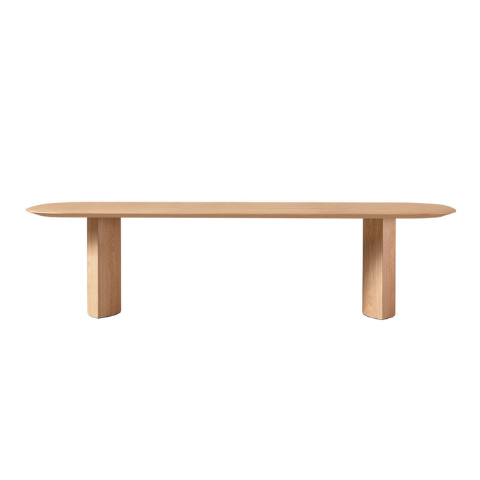 Light oak wood bench with a smooth, oval top and minimalist cylindrical legs. Natural finish, no distinct patterns.