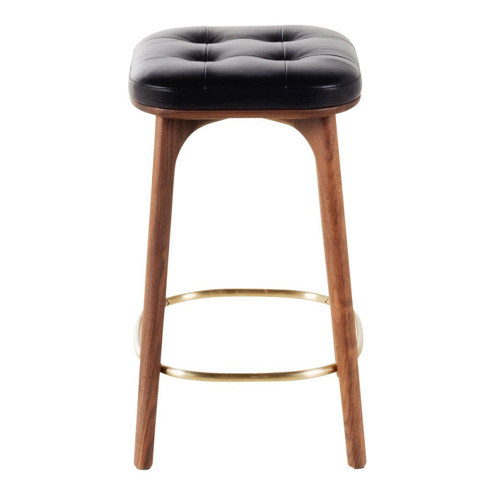 Black tufted cushion bar stool with natural wood legs and gold footrest accents.