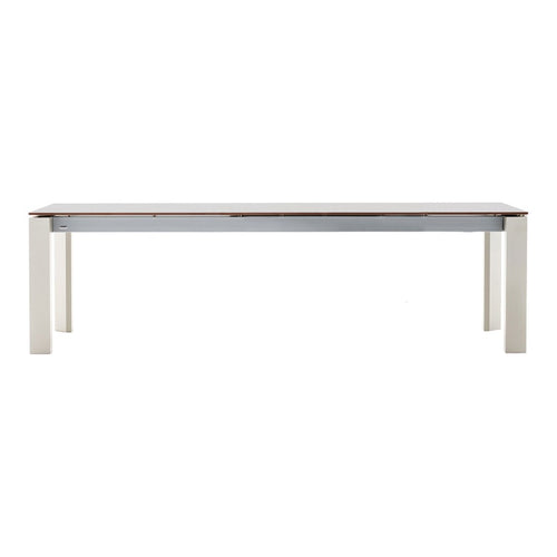 Long rectangular dining table with a white surface and light wood accents. Minimalist design, perfect for modern decor.