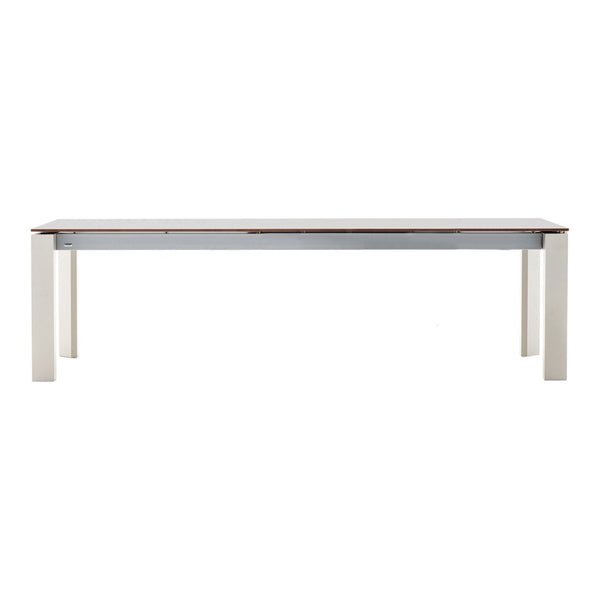 Light wood dining table with a smooth white surface and neutral-colored legs, featuring a clean, modern design.
