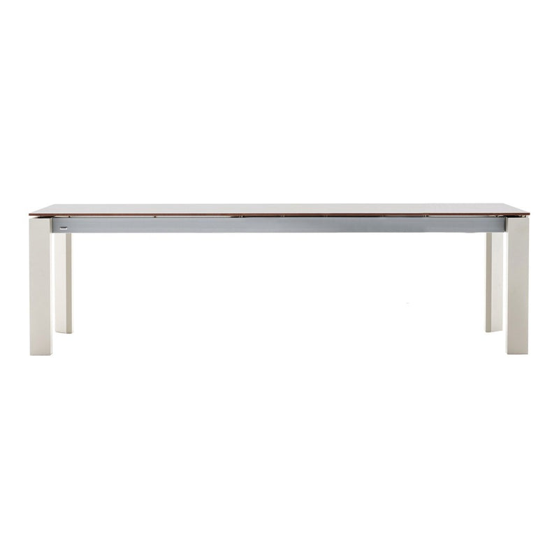 Light wood dining table with a smooth white surface and neutral-colored legs, featuring a clean, modern design.
