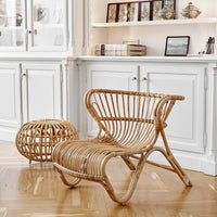 Natural rattan chair and ottoman with a warm, textured finish, showcasing a stylish woven pattern against a light background.