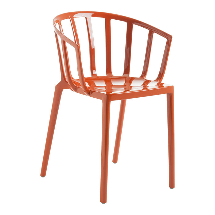 Bright orange chair with a sleek, modern design and open slatted backrest. Ideal for adding a pop of color to any space.