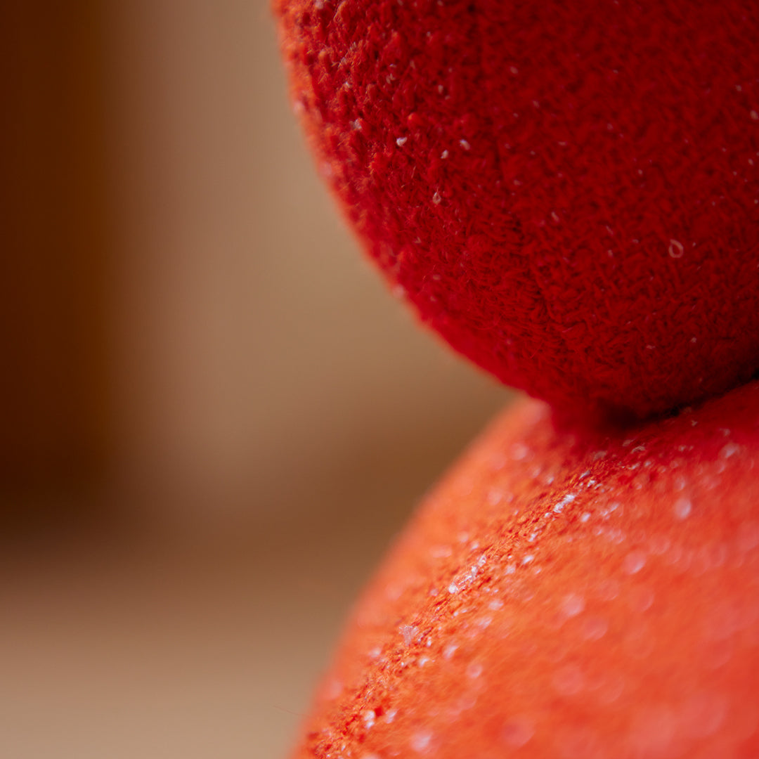 Close-up of vibrant red fabric showcasing textured patterns and subtle sheen details. Ideal for color enthusiasts.