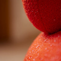 Close-up of vibrant red fabric showcasing textured patterns and subtle sheen details. Ideal for color enthusiasts.