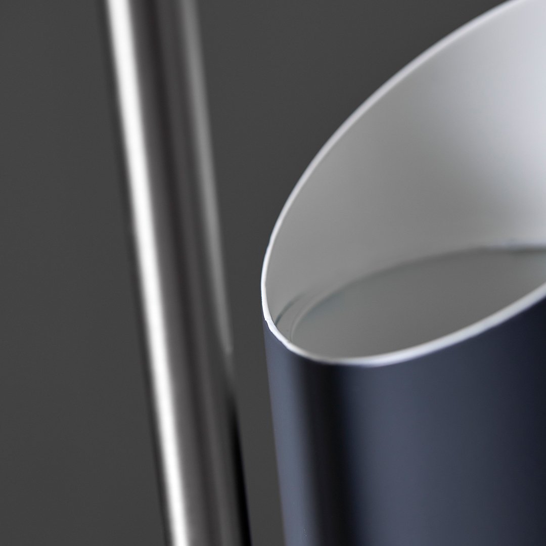 Sleek silver and deep navy water pitcher with a smooth, curved design and a glossy finish.
