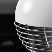 Close-up of a sleek white mixer head with a shiny silver wire guard, against a dark background.