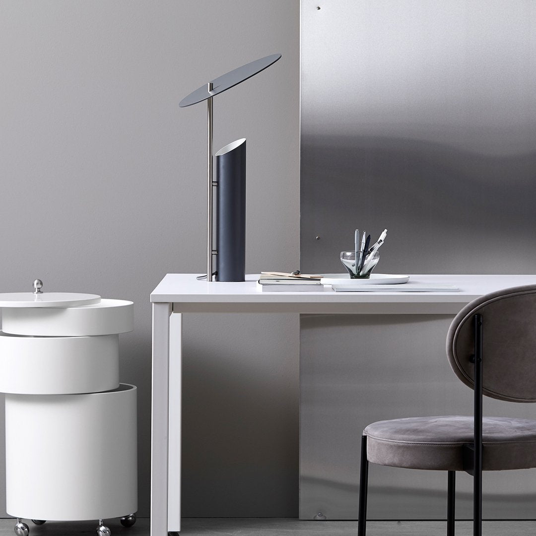 Sleek gray and white office setting featuring a minimalist design with subtle metallic accents and a modern lamp.
