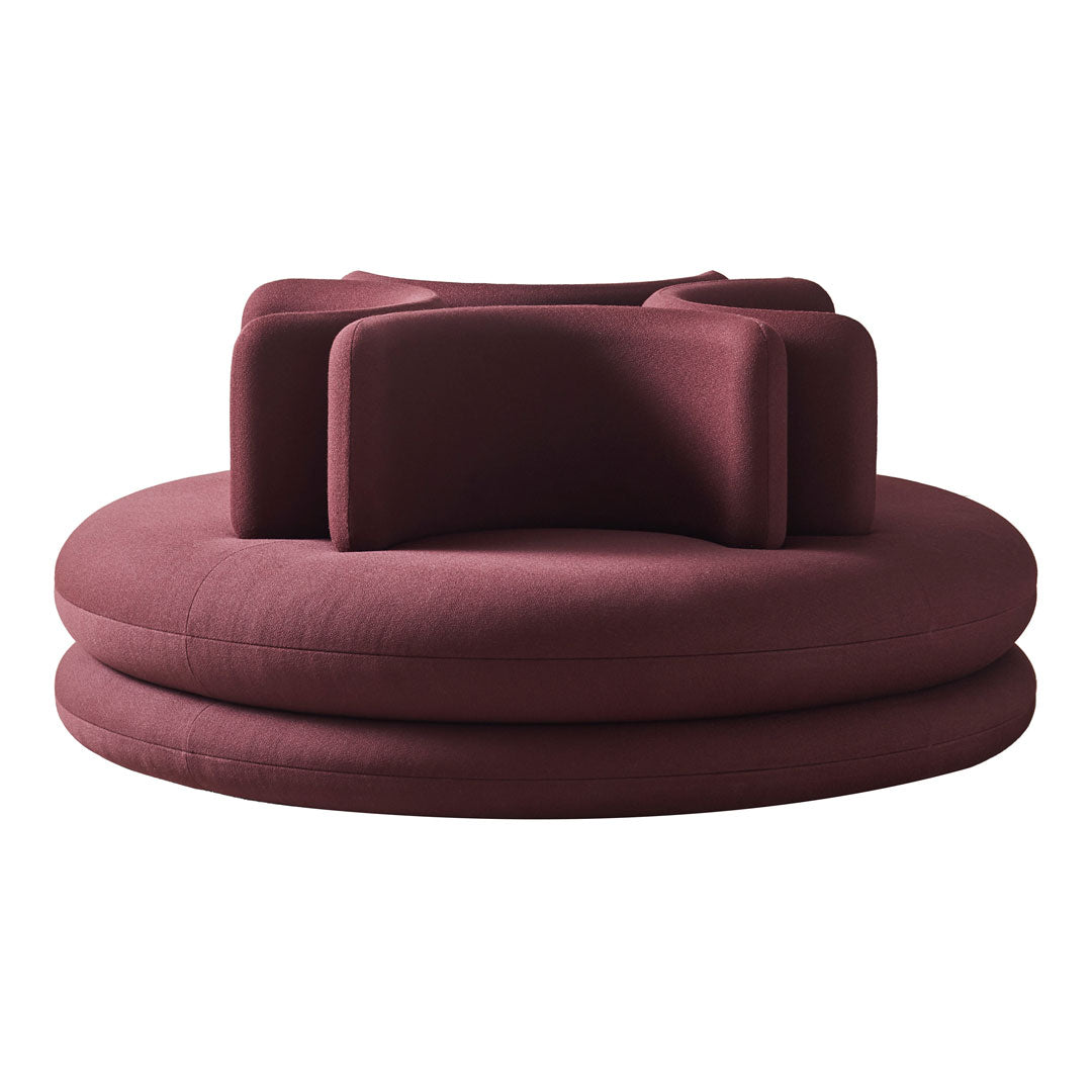 Round burgundy lounge chair with a textured fabric and modern, layered design, perfect for contemporary interiors.