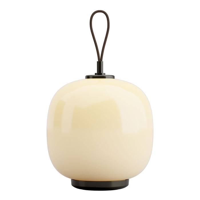 Ivory ceramic lamp with a smooth, rounded shape and a sleek black metal base and handle. Perfect for modern decor.