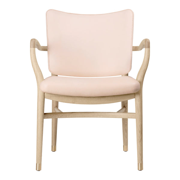 Blush pink upholstered chair with light wooden frame, featuring a minimalist design and smooth curves.
