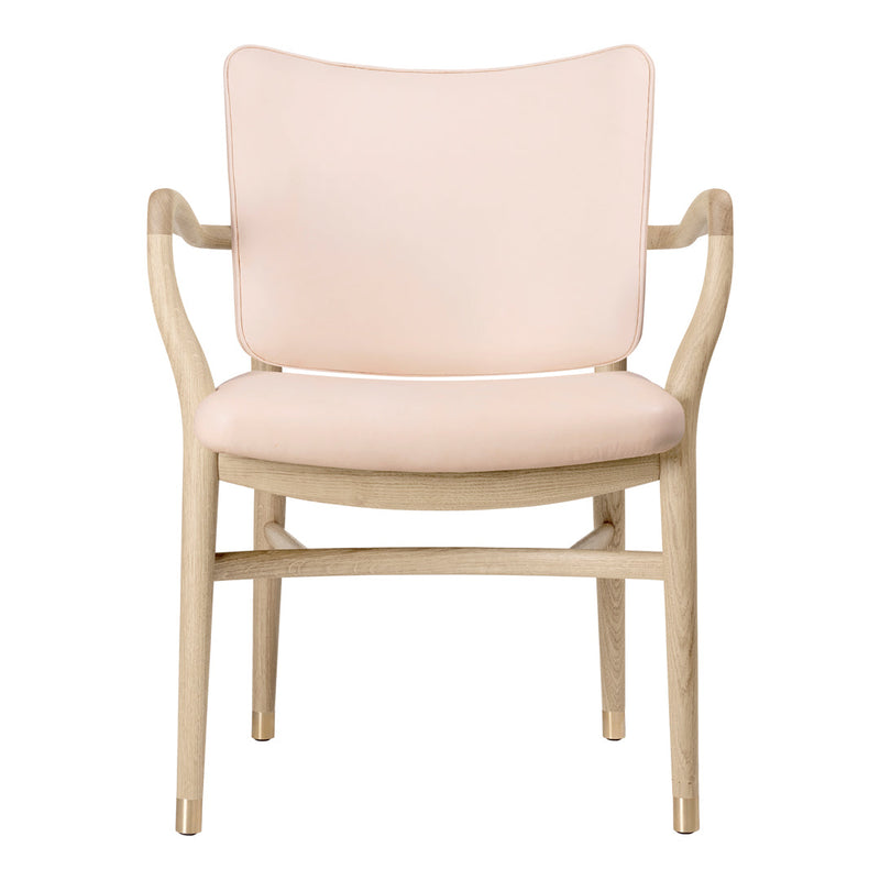 Blush pink upholstered chair with light wooden frame, featuring a minimalist design and smooth curves.