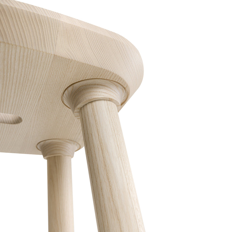 Natural wood finish with smooth texture and subtle light grains; elegant round legs add modern sophistication.