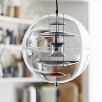 Clear glass orb pendant light with metallic accents in silver and vibrant red, showcasing a modern, minimalist design.