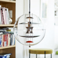 Clear spherical pendant light featuring layered metallic accents in bronze, silver, and a pop of red. Perfect for modern decor.