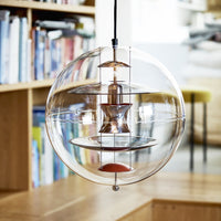 Clear glass pendant lamp with copper accents and a circular, modern design. Sleek and contemporary home decor.