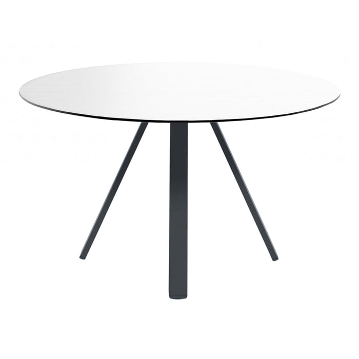 Round white table with sleek black legs, showcasing a minimalist design and modern aesthetic.