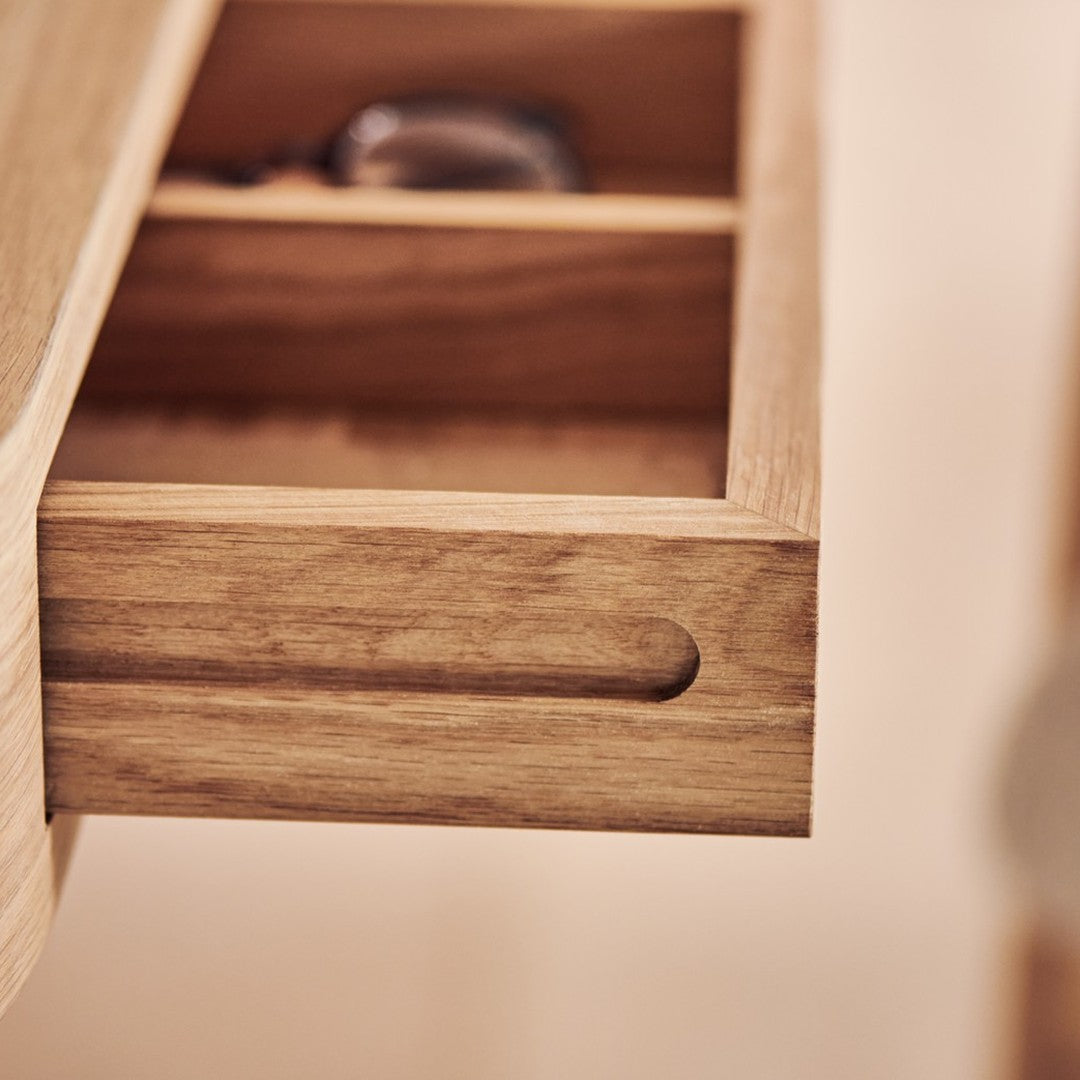 Light oak drawer with a smooth finish and natural wood grain pattern. Elegant and minimalist design.