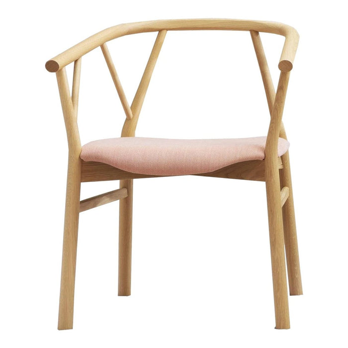 Light wood chair with a minimalist design and a soft pink fabric seat, featuring a modern crossed back pattern.