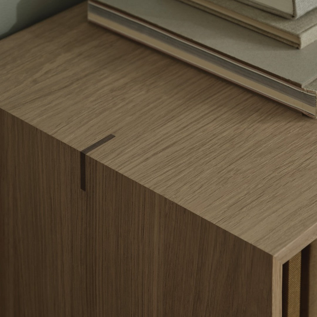 Wooden cabinet with a smooth, natural grain pattern in warm brown tones, complemented by minimalist design elements.