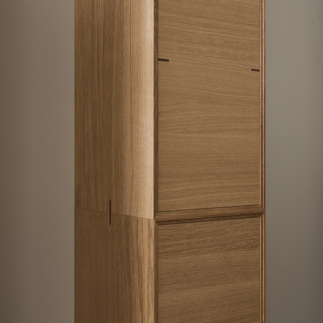 Wooden cabinet featuring a smooth, natural finish with a warm, light brown color. Minimalist design and clean lines.