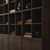 Dark wood shelving unit with a grid pattern, showcasing earthy tones and ceramic decor accents.