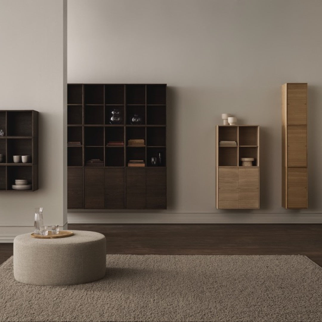 "Contemporary furniture display with dark wood and light natural finishes, featuring clean lines and subtle textures."