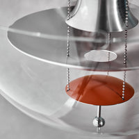 Modern pendant light featuring transparent glass, vibrant orange accents, and sleek chrome details.