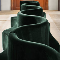 Curved, plush sofa in deep emerald green velvet, showcasing a unique wave pattern for a modern, stylish look.