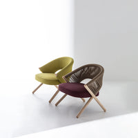 Green and maroon accent chairs with wooden legs and stylish woven backs, perfect for modern decor.