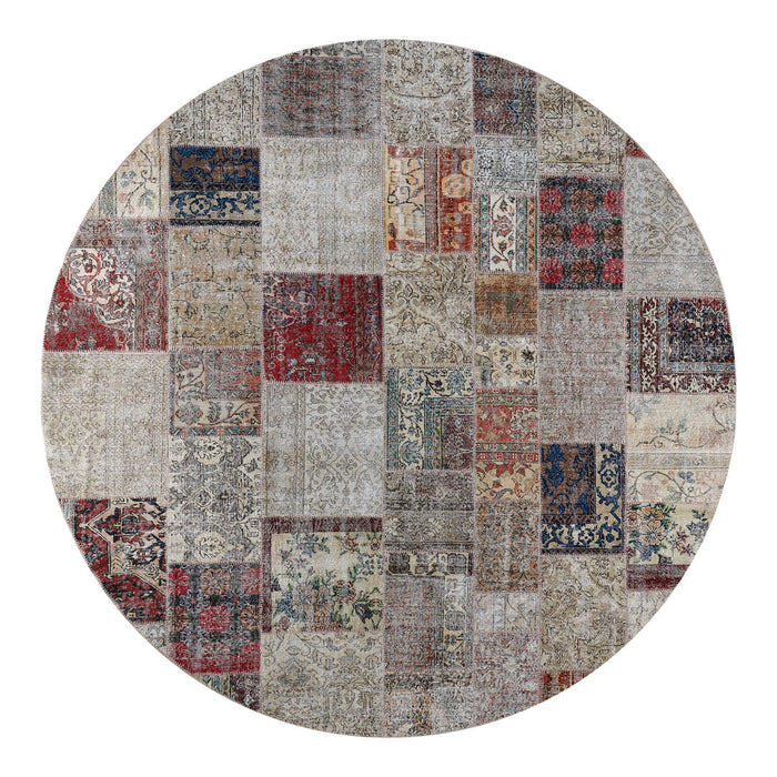Round area rug featuring a patchwork design with various intricate patterns in red, blue, gray, and beige tones.