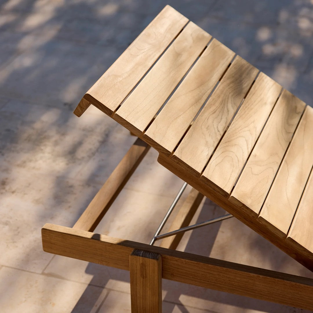 Natural wood tone with smooth, slatted pattern on a adjustable lounge chair, highlighting a warm, earthy aesthetic.