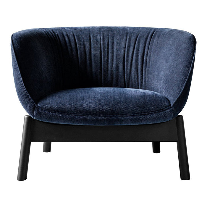 Navy blue velvet chair with plush ribbed detailing and sleek black wooden legs. Perfect for modern decor.