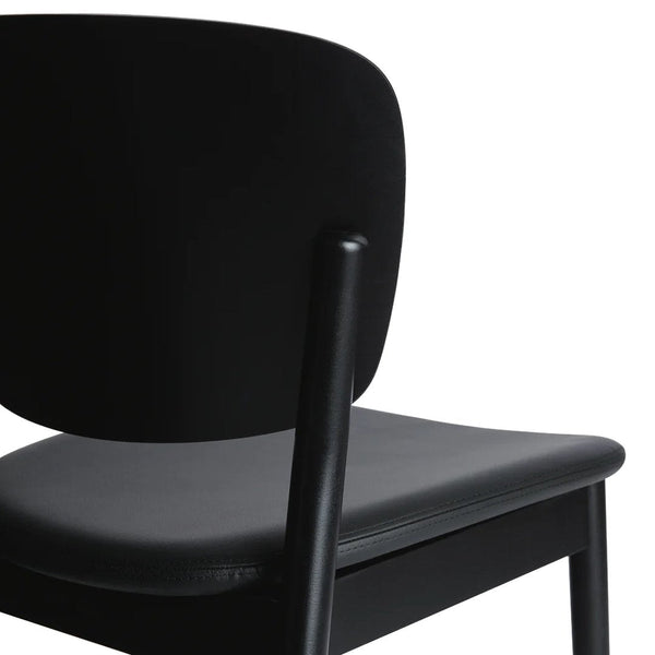 Black chair with a smooth matte finish and a contrasting gray seat, showcasing a minimalist design.