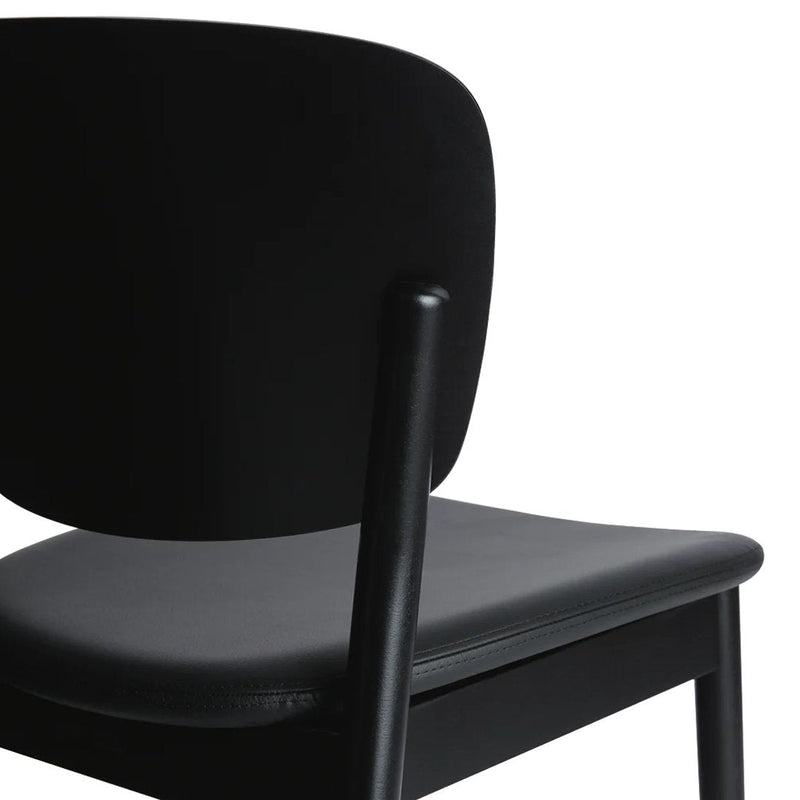 Black chair with a smooth matte finish and a contrasting gray seat, showcasing a minimalist design.