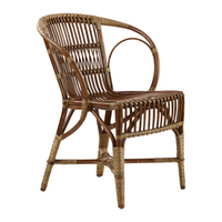 Natural brown rattan chair with a woven pattern and curved armrest, perfect for bohemian decor styles.