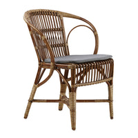 Stylish rattan chair in natural brown tones, featuring a sleek gray cushion and intricate woven patterns.
