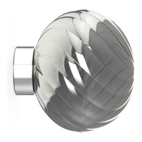 Clear glass knob with swirling patterns and a polished chrome base, adding elegance to any decor.